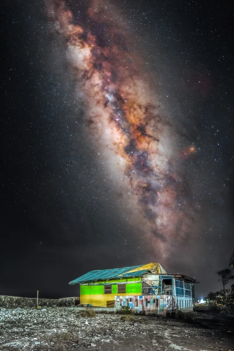 The Milky Way rising over a brightly coloured house — captured on a smartphone