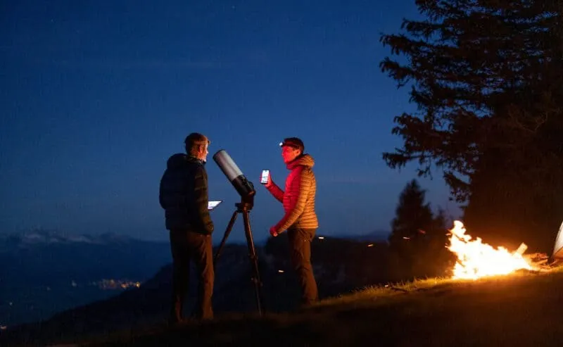 A smart telescope set up under the night sky